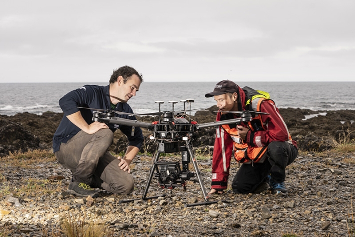 NIWA researchers Hamish Sutton and Leigh Tait are setting up a drone with a 6-band multispectral camera and a Sony a5100 mirrorless camera for marine reserve mapping near Wellington. [Photo: Rebekah Parsons-King / NIWA]