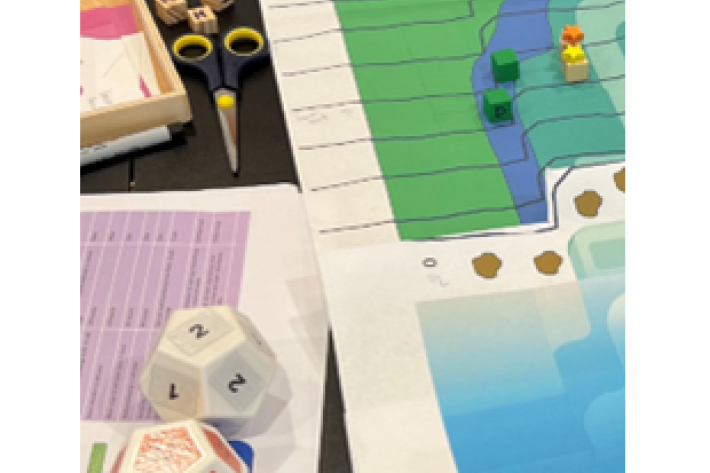 Close up shot of Future coasts multi-hazard game board, dis, a pair of scissors on a desk