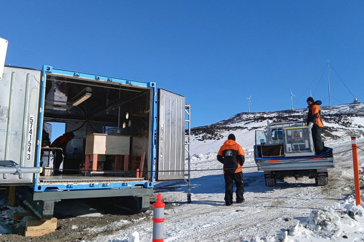 AERI installation at Scott Base's Long term science building facility with Scott Base wind farm in the background.
