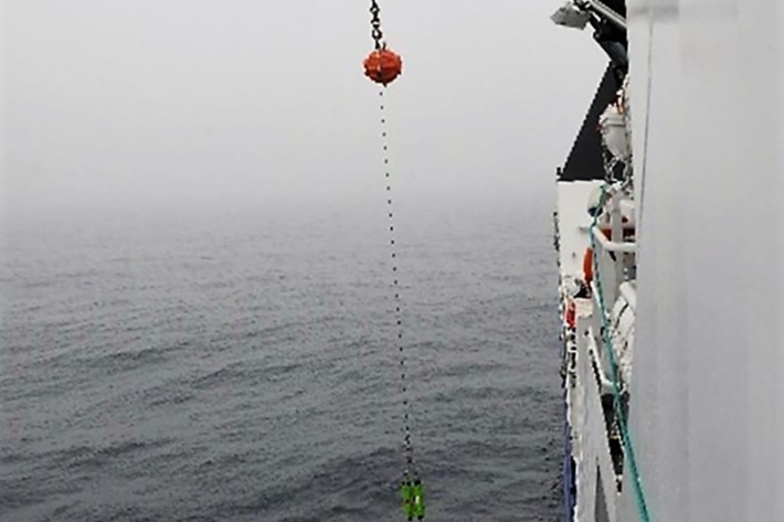 Passive acoustic mooring deployed from side of the ship into ocean water.