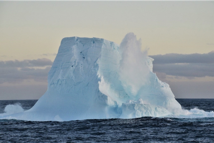 Iceberg on water with a snow blowhole
