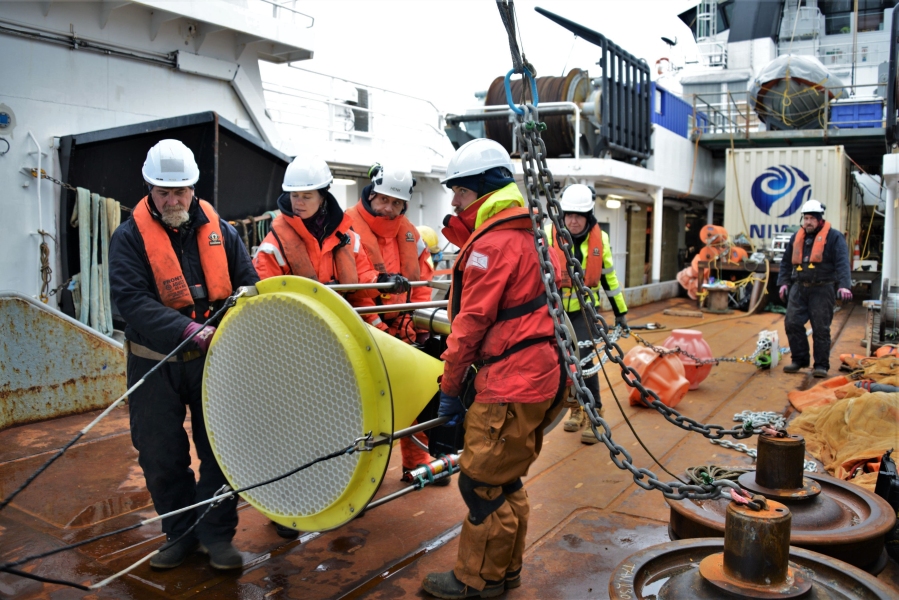 Researchers onboard RV Tangaroa deploying sediment trap mooring equipmentt