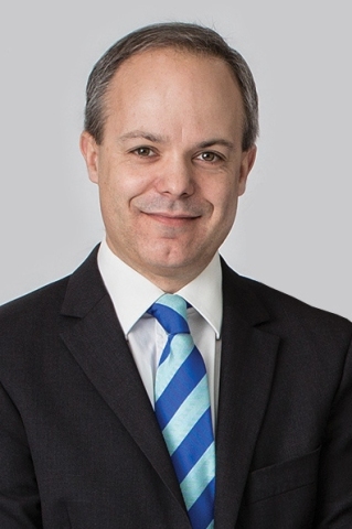 Headshot of Patrick Baker, Chief Financial Officer and Company Secretary, in a suit and tie