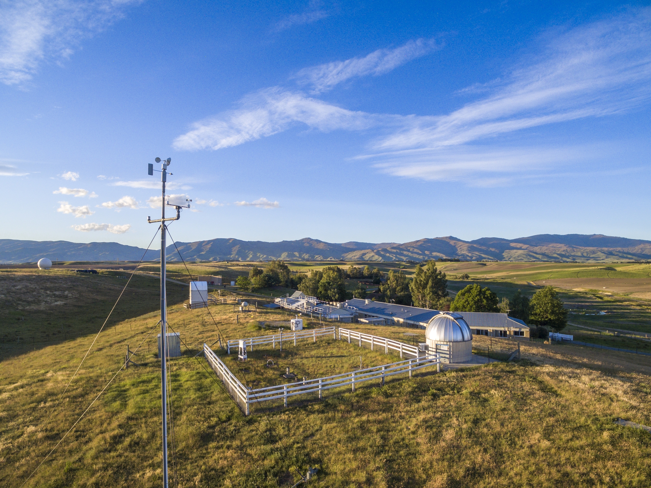 Side aerial shot of Lauder Atmospheric Research Station on a bright sunny day