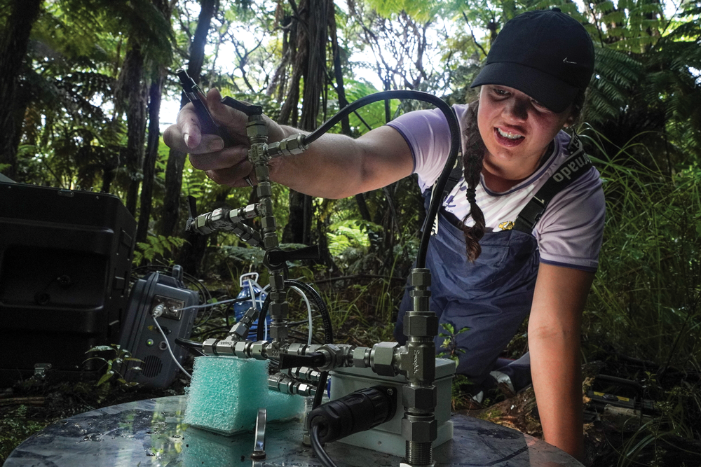Kararaina collecting soil/air samples in Raukūmara forest. 