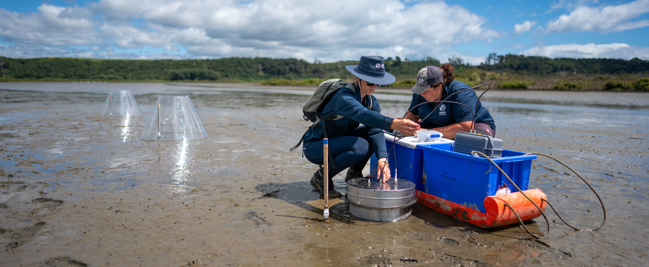 Earth Science NZ researchers Sarah Hailes and Emily Douglas take gas measurements from the sediment in Waihi estuary