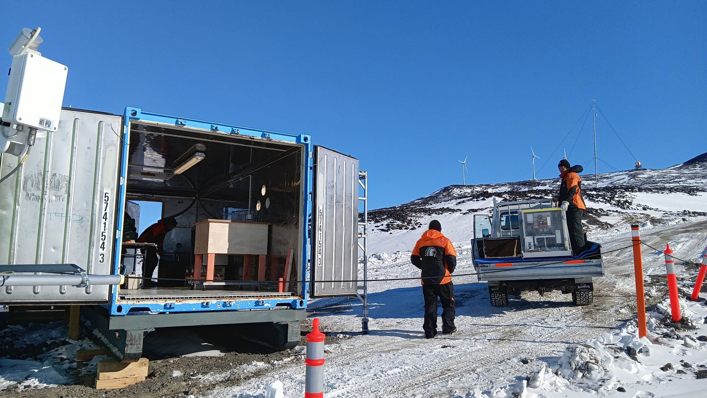 AERI installation at Scott Base's Long term science building facility with Scott Base wind farm in the background.
