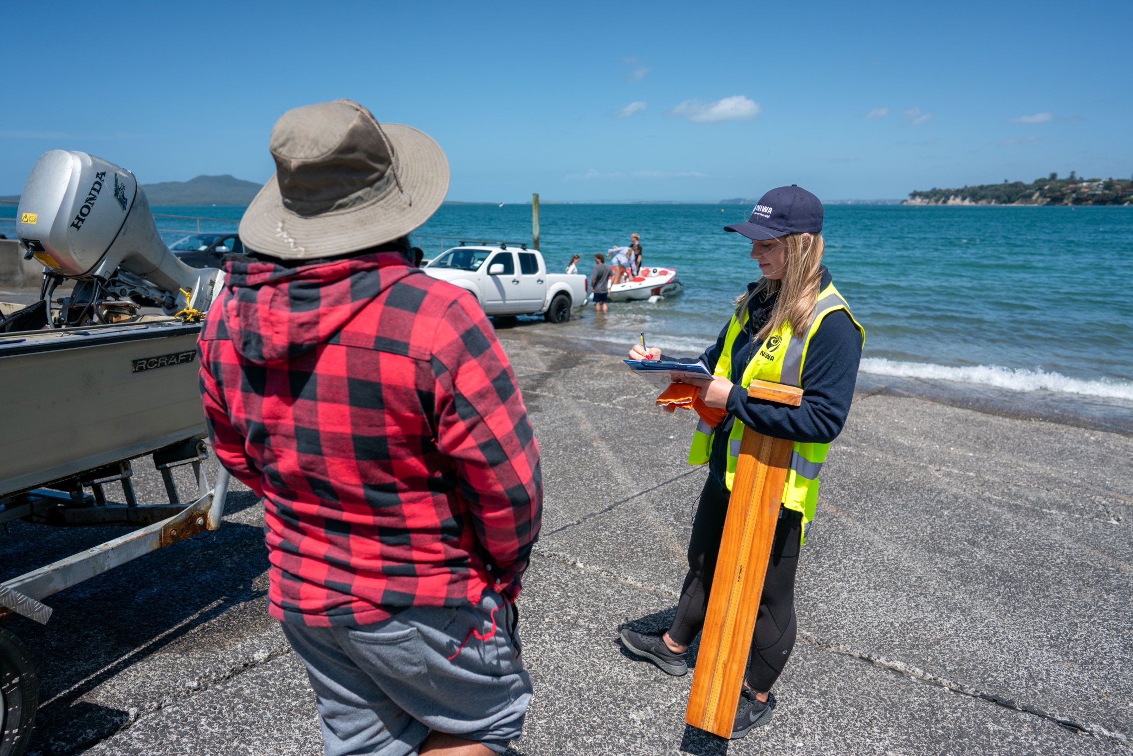 Fisheries scientist conducting boat ramp interview with a fisher.