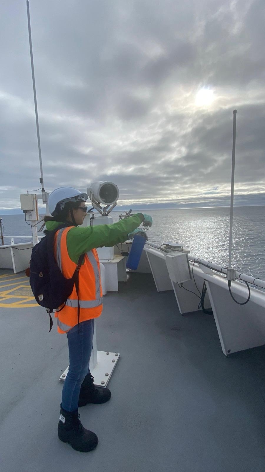 Hana Ishii collects an air flask sample atop Tangaroa