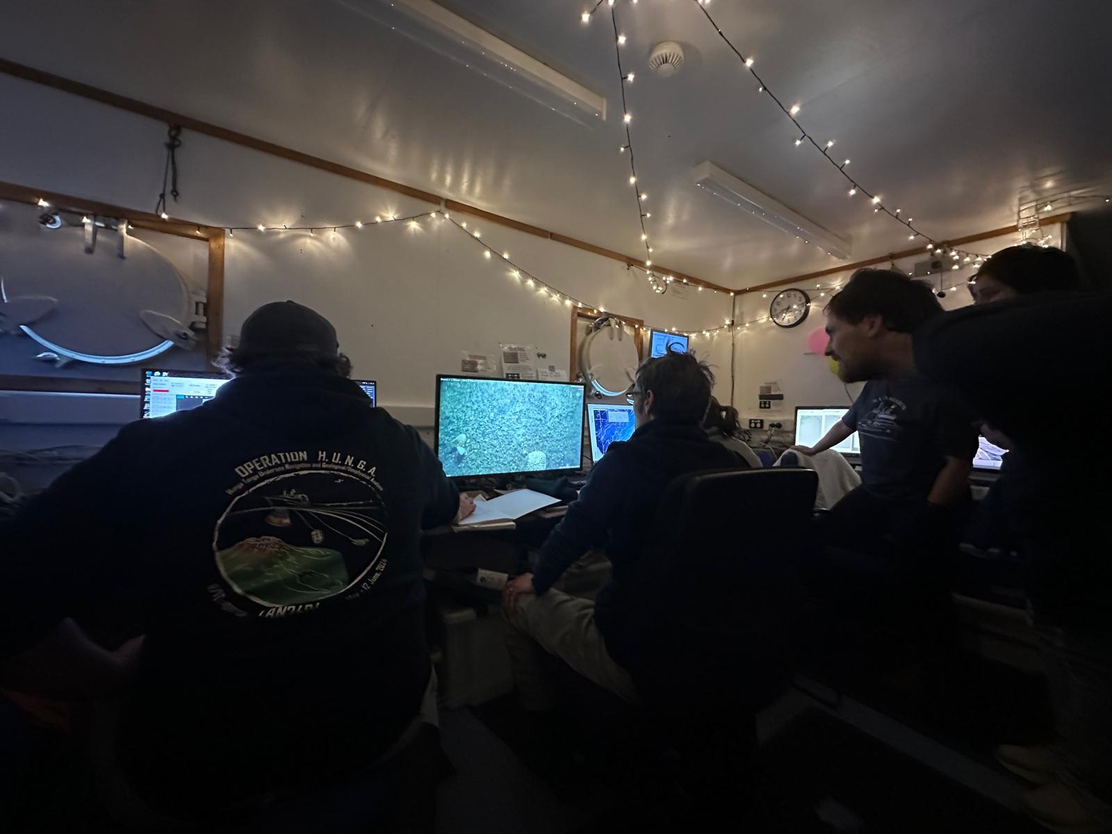 Team gathers to watch the deep towed imaging system